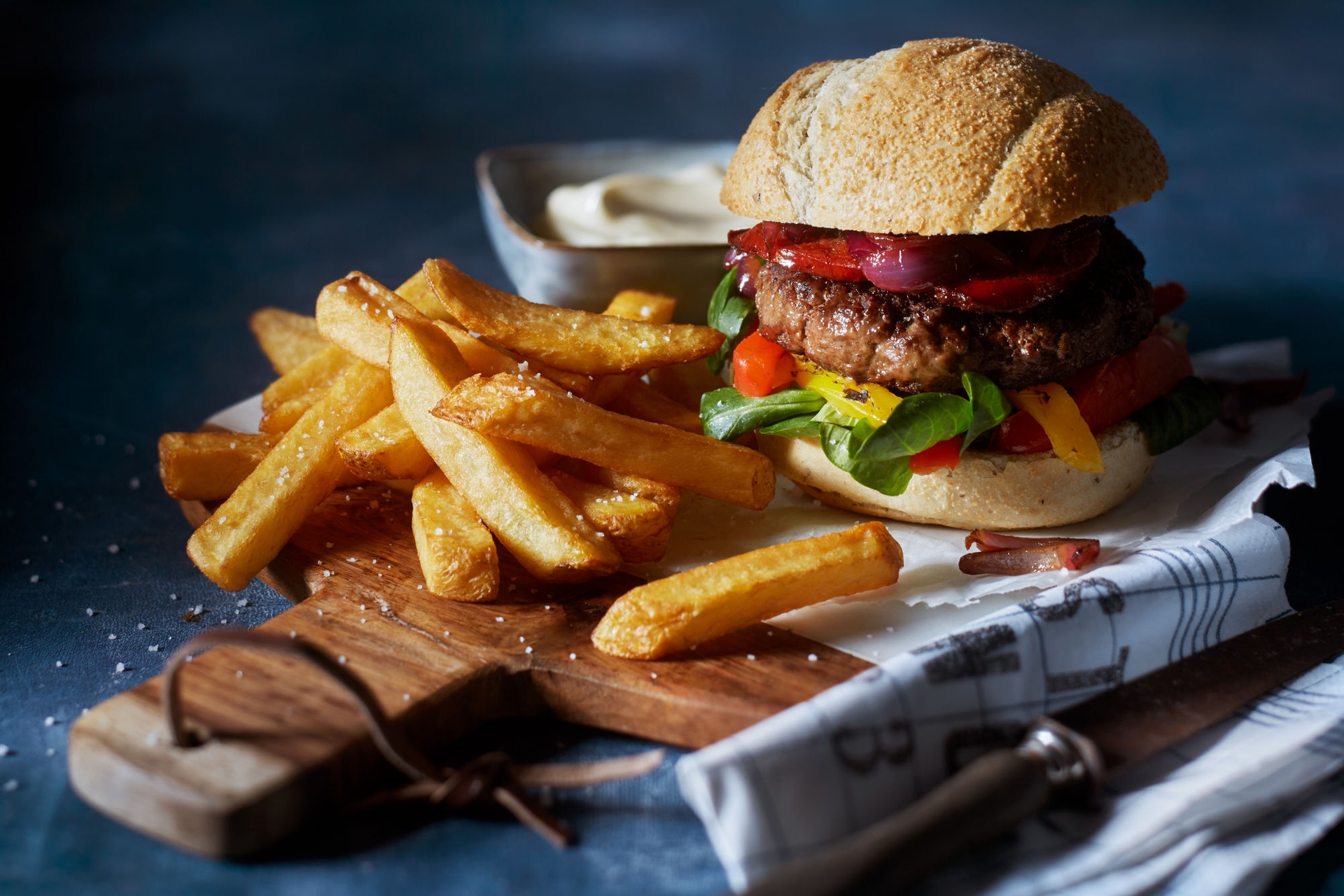 Burger se salámem chorizo, opečenou paprikou a karamelizovanou cibulkou